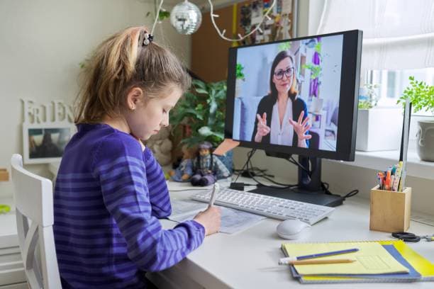 A student in a one-to-one online tuition session with her tutor
